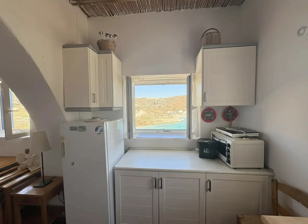 Cozy Cycladic studio room at Casa Mersini with white walls and blue door