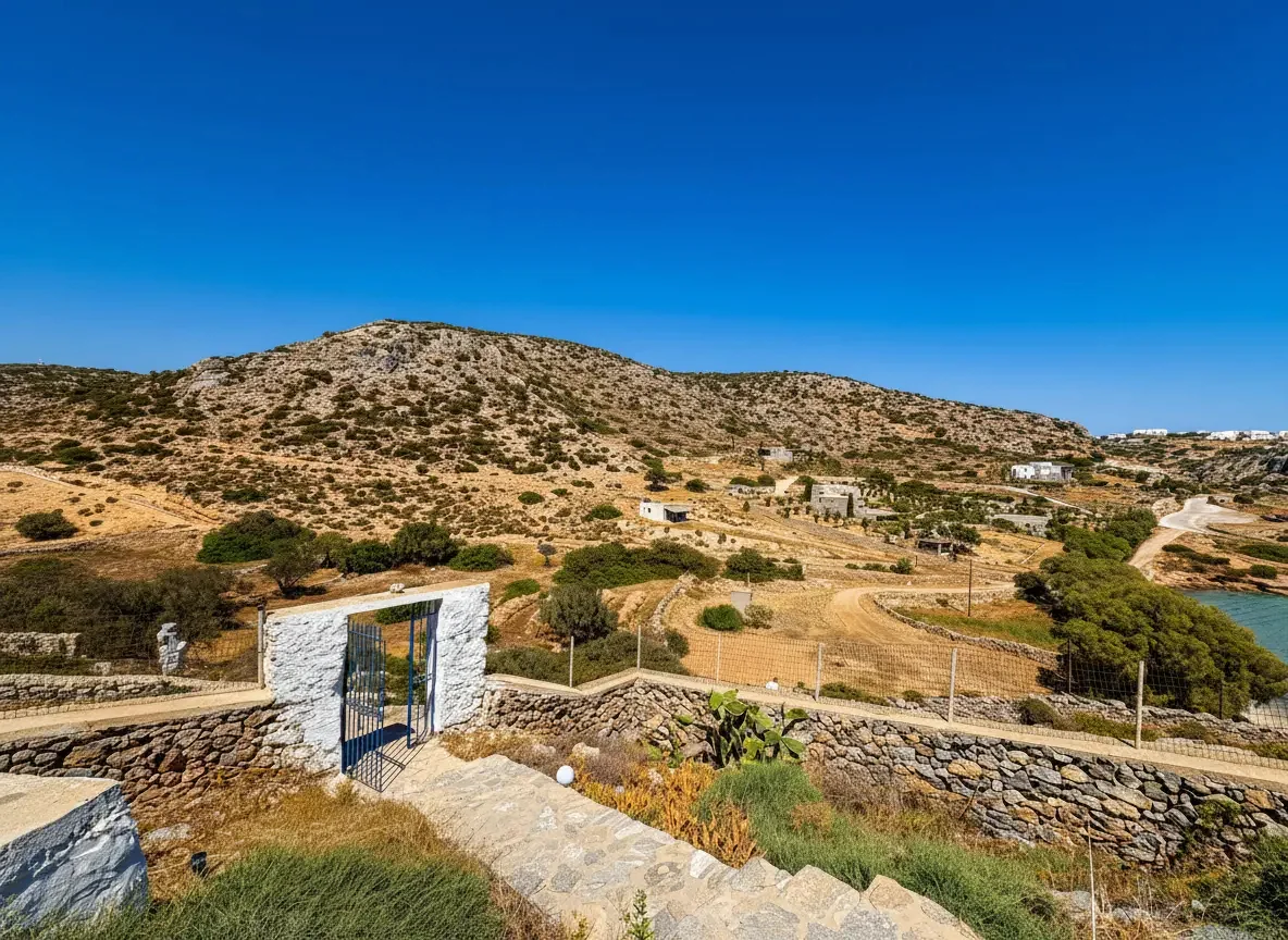 Outdoor terrace at Casa Mersini with stone path and sea view